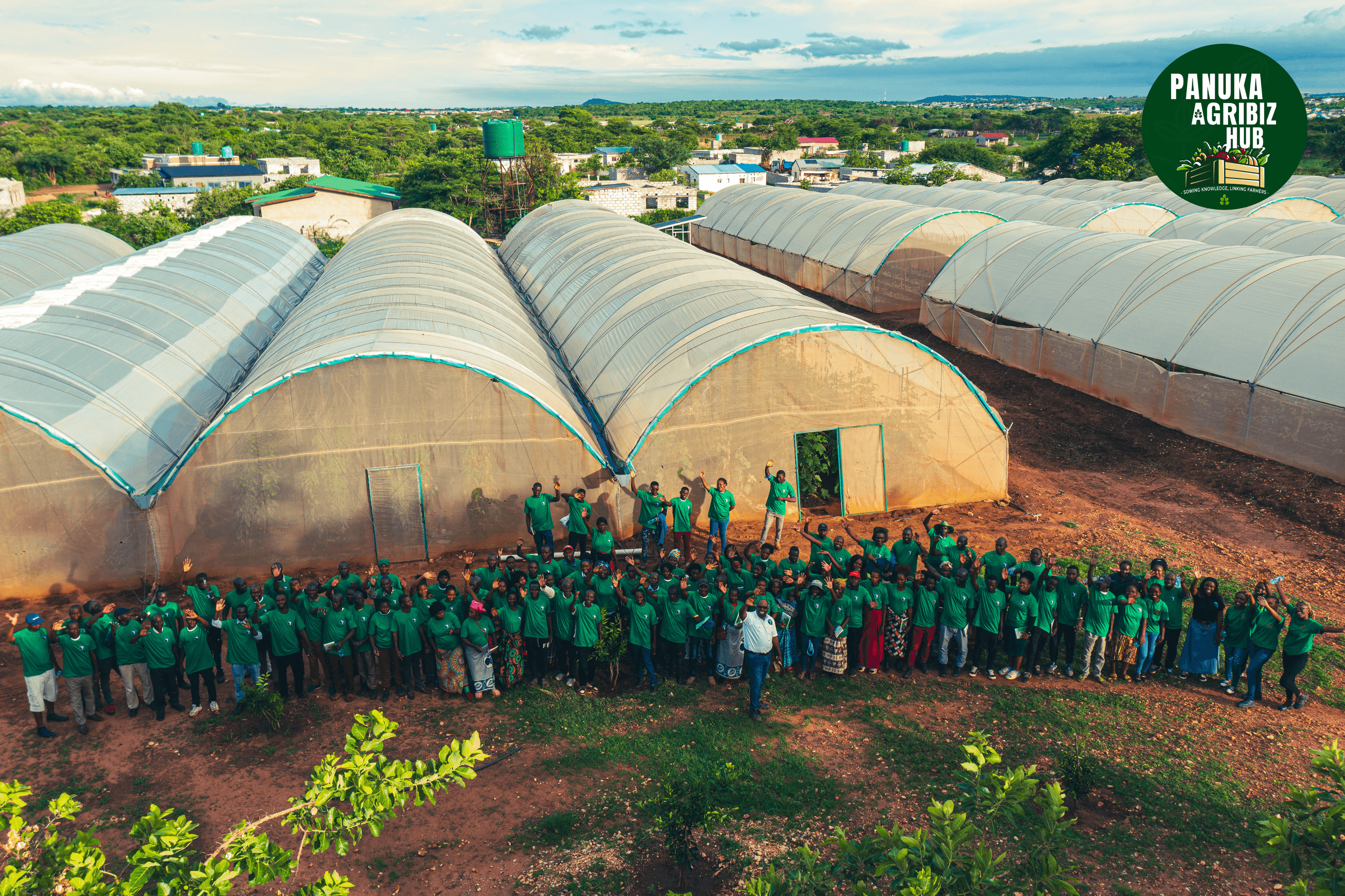 Cohort of farmers at Panuka Farm greenhouse complex during a bootcamp